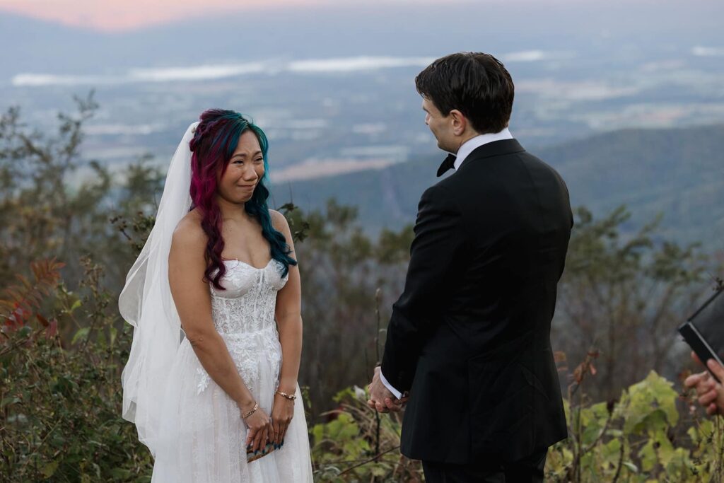 A bride cries while her husband reads his vows to her on their elopement day in Shenandoah. 