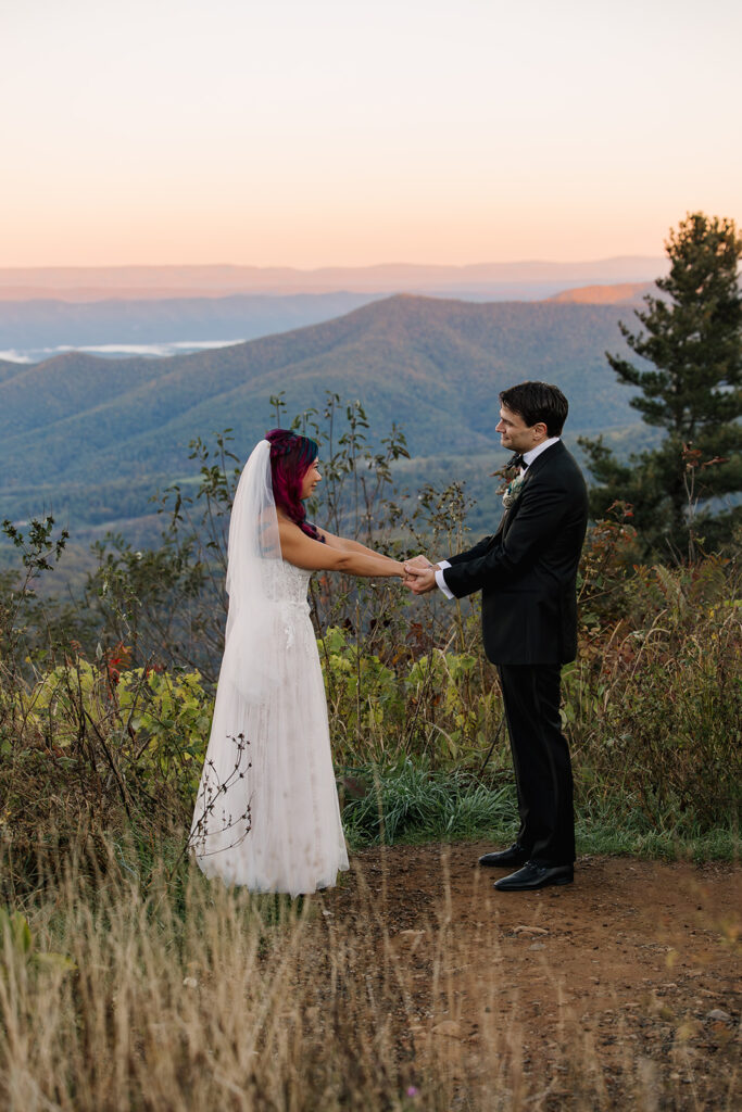 A bride and groom hold hands during their elopement ceremony in Shenandoah National Park