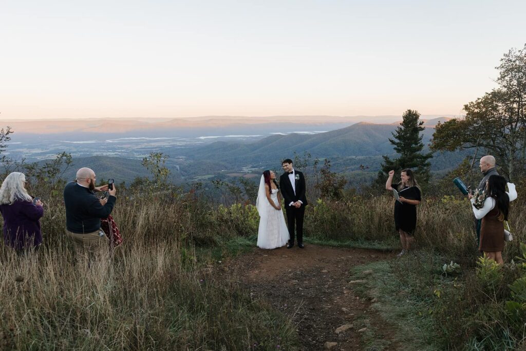 A bride and groom stand in front of their immediate family after being pronounced husband and wife on their elopement ceremony at Jewell Hollow