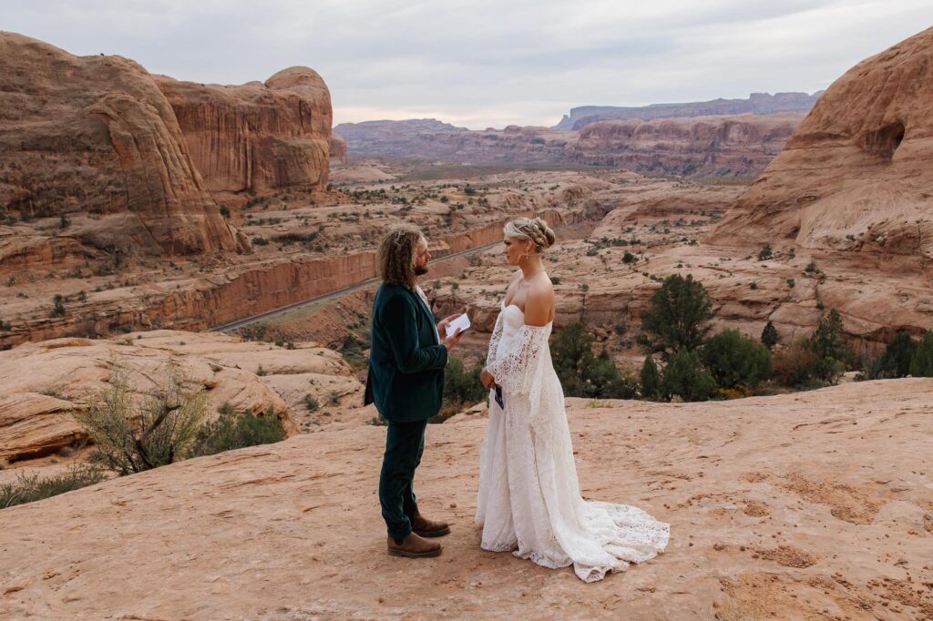 A bride and groom exchange vows in the middle of the Moab desert