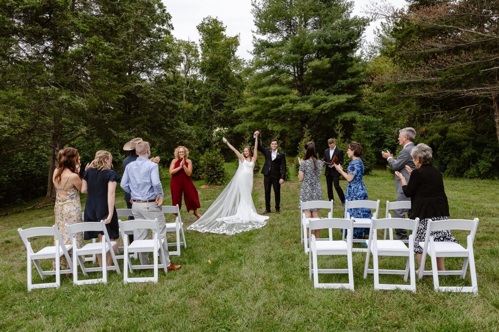 A bride and groom celebrate officially being married in front of their family during their Virginia wedding
