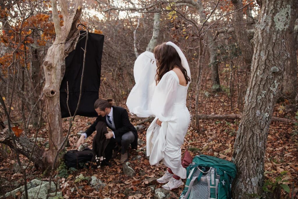 A bride and groom getting reayd for their sunrise elopement in the woods of Shenandoah before the sunrises.