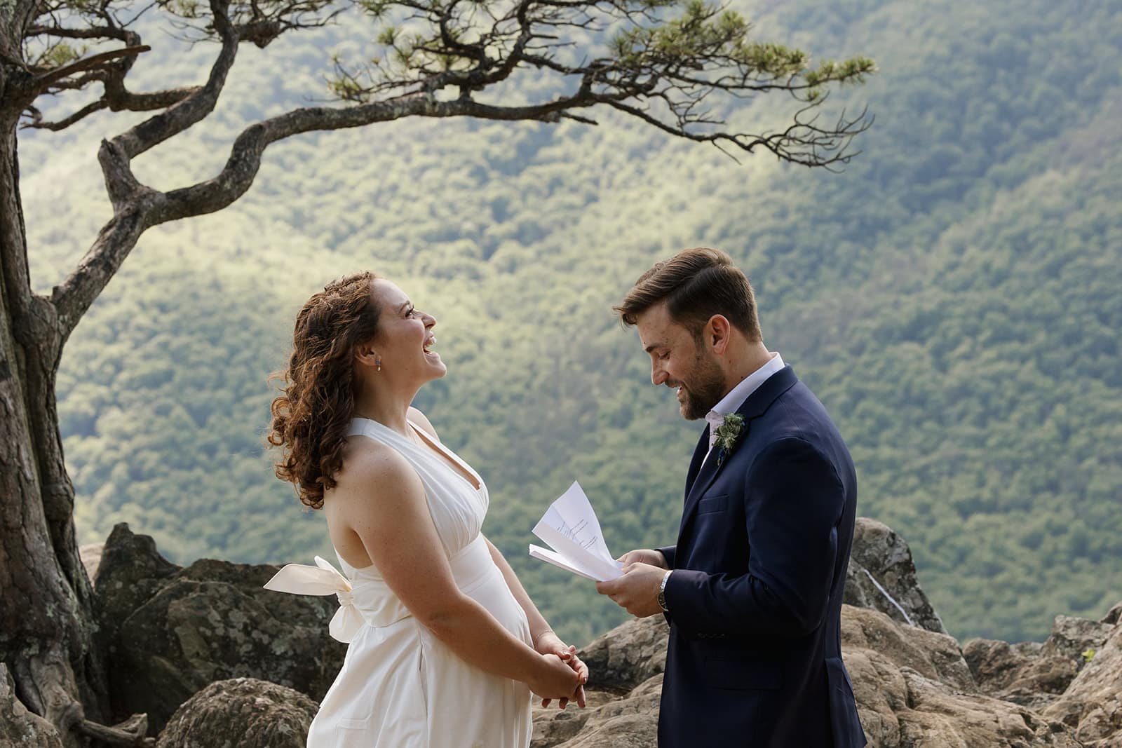 A groom reads his personal vows to his bride during their elopement at Raven's Roost on the Blue ridge Parkway