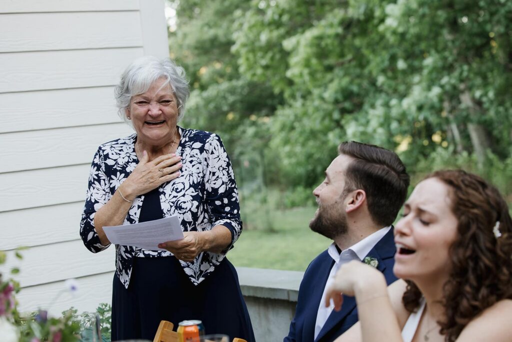 The mother of the groom gets emotional as she toasts her son and his new wife during their intimate elopement at Indigo House