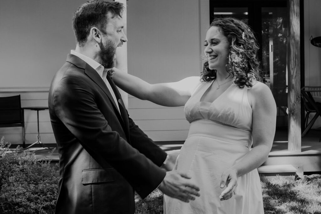 A groom leans in for a hug after seeing his bride for the first time on their elopement day. The bride is smiling, and grooms mouth is wide open with absolute joy 