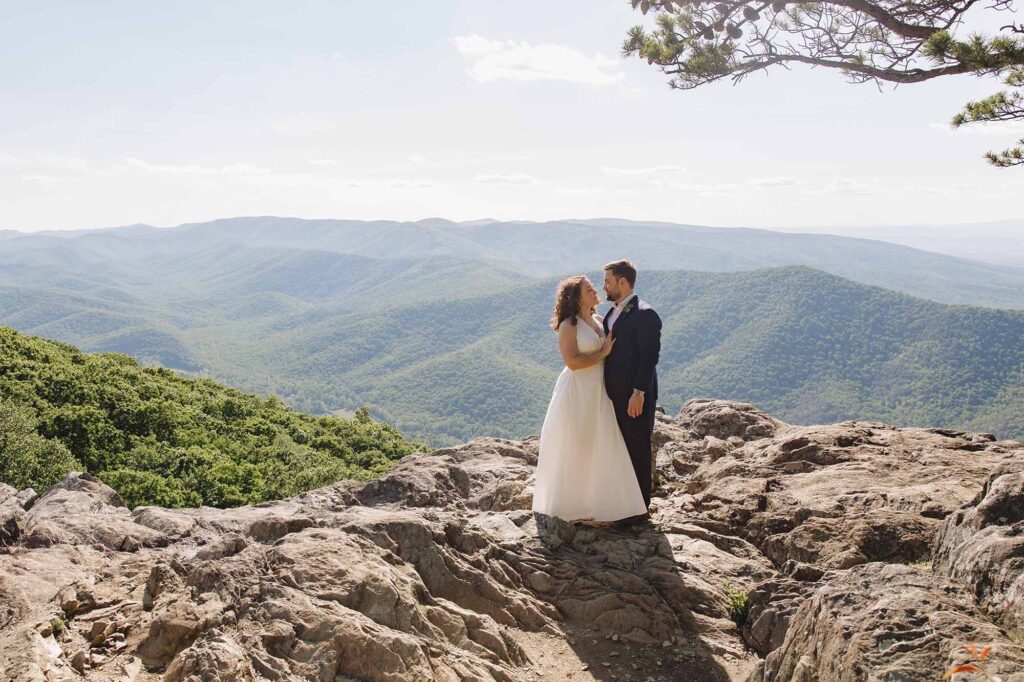 A bride and groom stand facing each other at Raven's roost during their intimate elopement