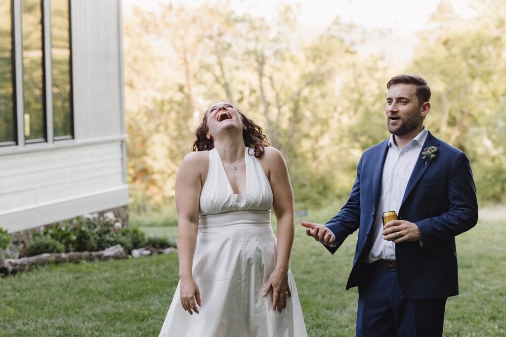 A bride laughs at the bad throw of her groom during a friendly game of bocce at cocktail hour