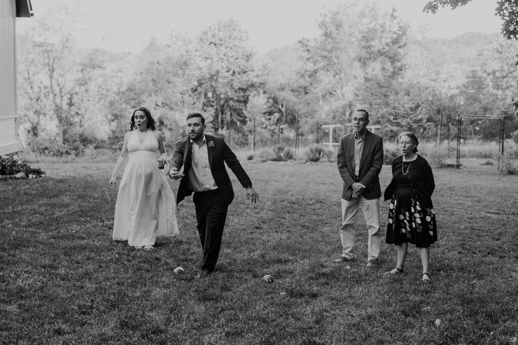 A groom makes a throw during an intense game of bocce during cocktail hour at his wedding at indigo house