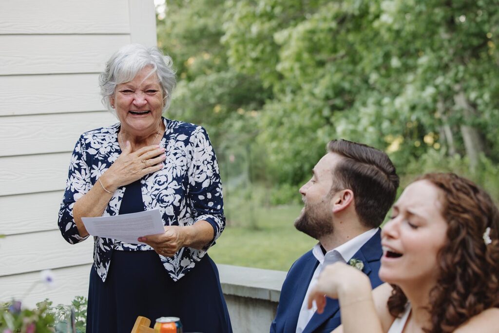 The groom's mother gets emotional as she gives a speech to the bride and groom during their intimate wedding reception at indigo house
